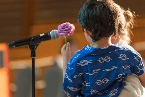 Children speak at microphone during service